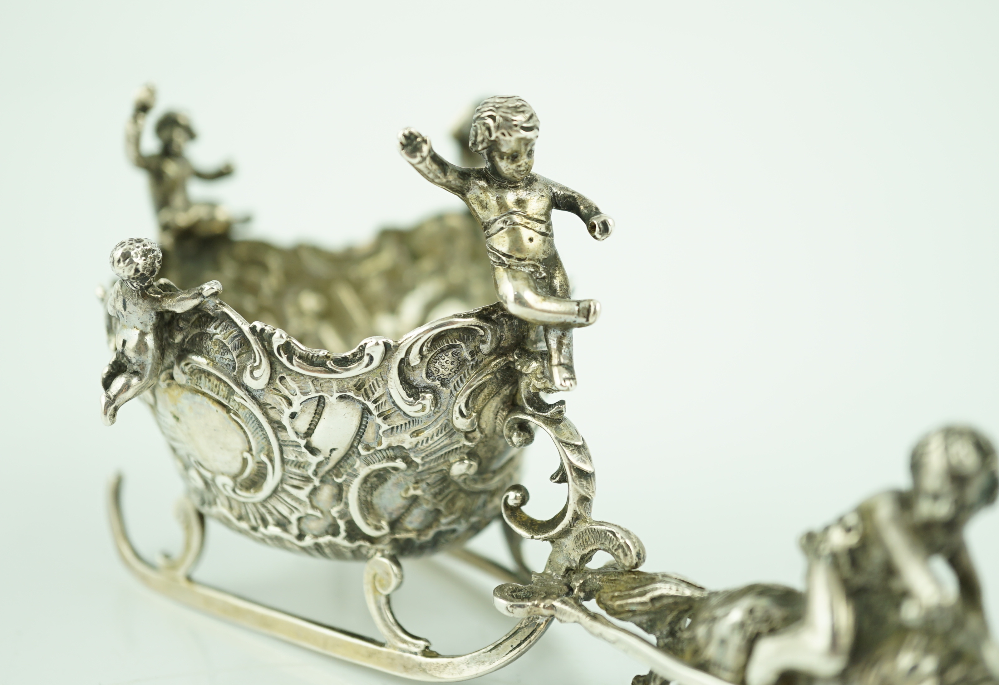 A late 19th century miniature silver model of a sleigh with putti, pulled by a goat, import marks for John George Smith